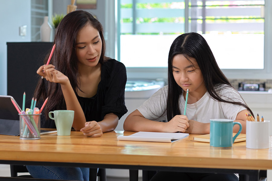 student and tutor together at a desk in Kent